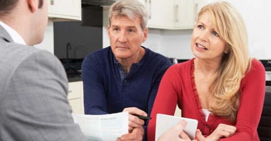 Mature Couple Meeting With Financial Advisor At Home