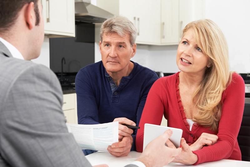 Mature Couple Meeting With Financial Advisor At Home