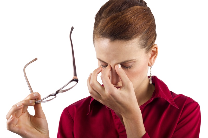 young businesswoman suffering from eyestrain