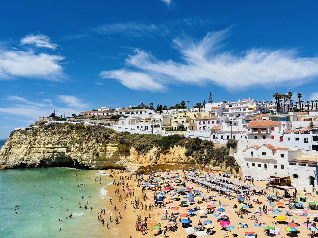 View of Carvoeiro fishing village with beautiful beach, Algarve, Portugal, colorful houses.