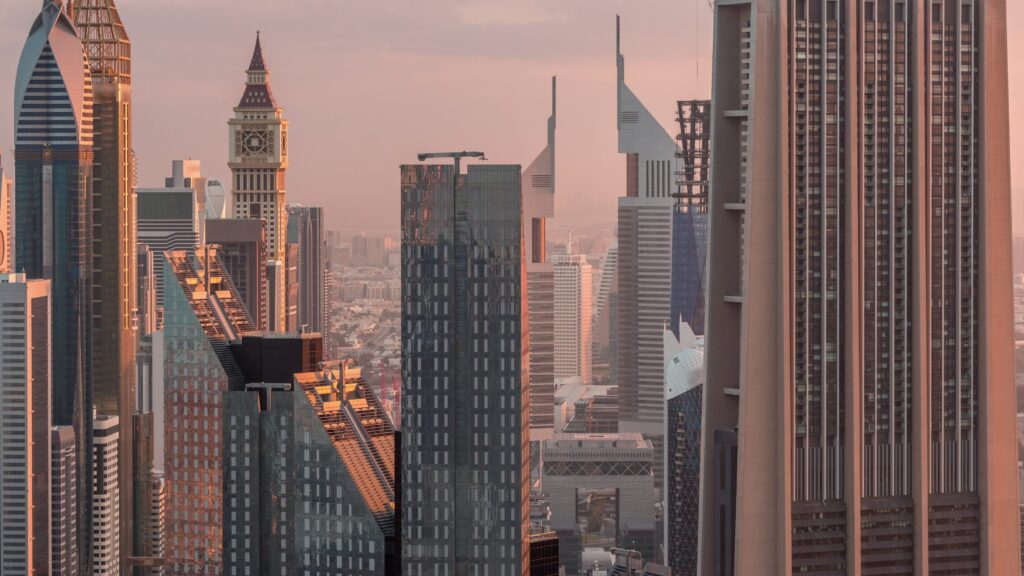 SPV holding company VCC UAE asset structuring guide for HNW investors - Dubai DIFC financial district skyline at sunset - The Michele Carby Practice