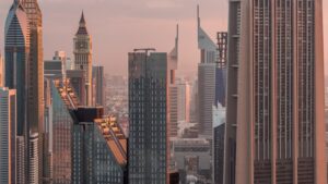 SPV holding company VCC UAE asset structuring guide for HNW investors - Dubai DIFC financial district skyline at sunset - The Michele Carby Practice